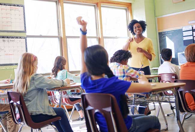 Student raising hand in classroom